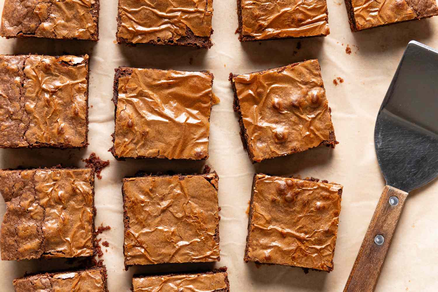 Overhead view of 3-ingredient brownies sliced into squares next to a serving spatula
