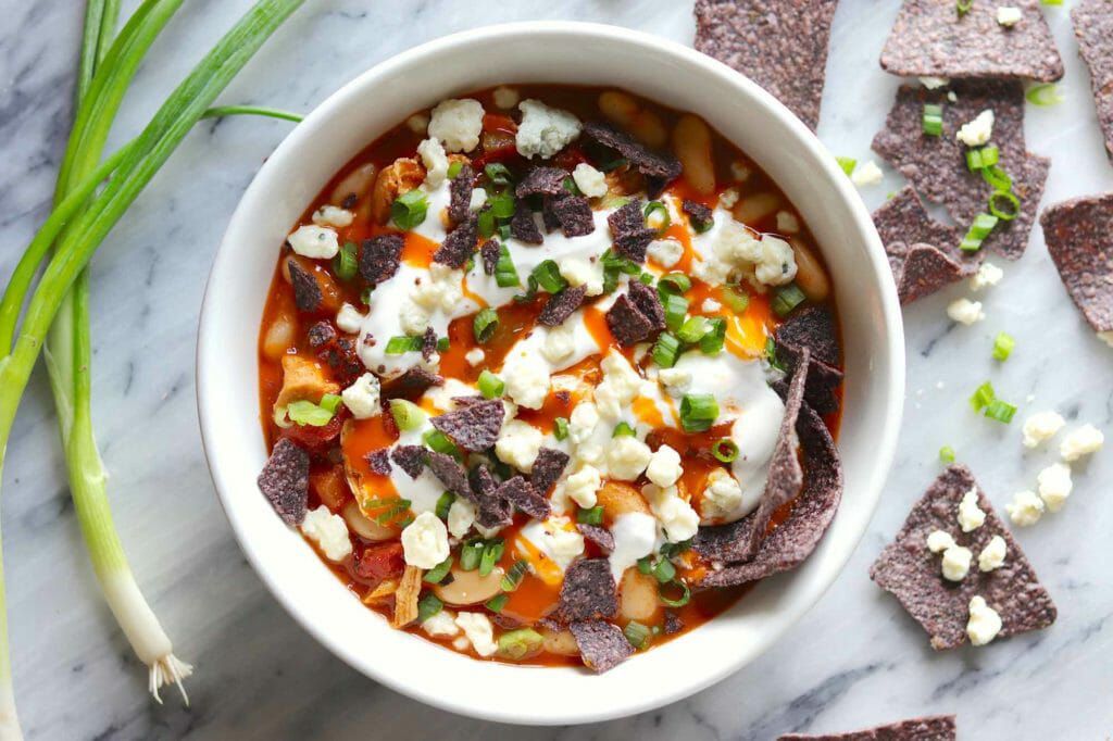 Bowl of buffalo chicken chili with blue cheese topping