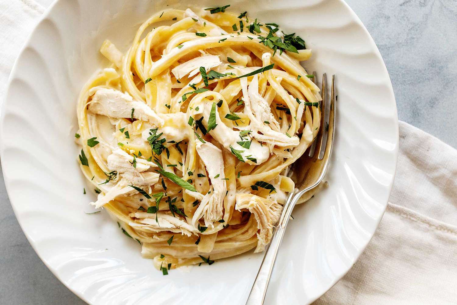 A serving plate of rotisserie chicken alfredo