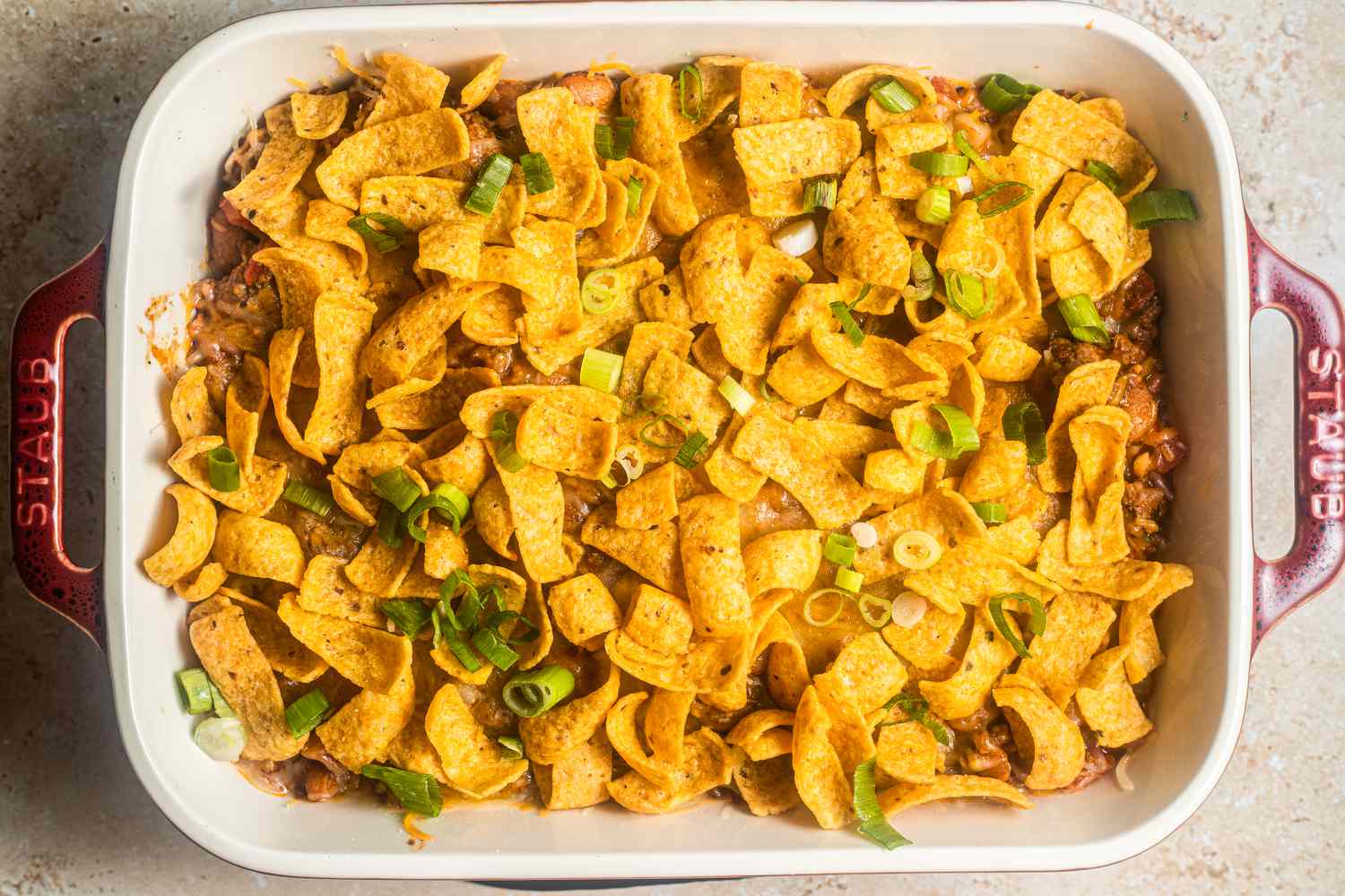 Baked walking taco casserole topped with Fritos chips