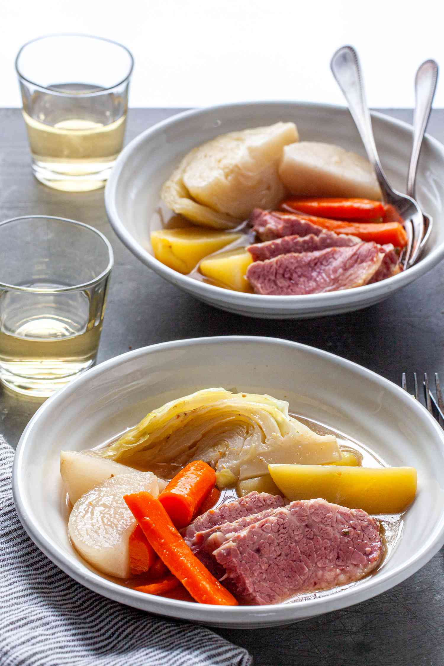 New England Boiled Dinner in dinner plates at a table 