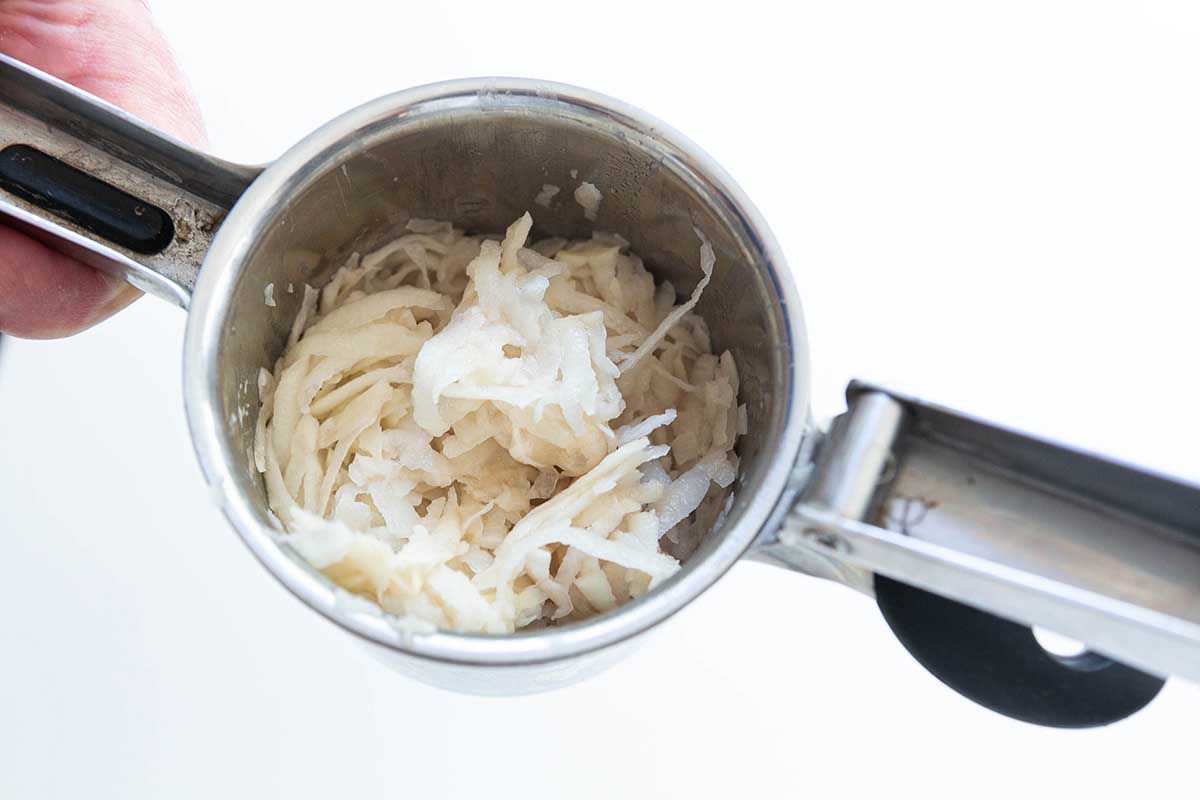 Shaved potatoes resting in a ricer