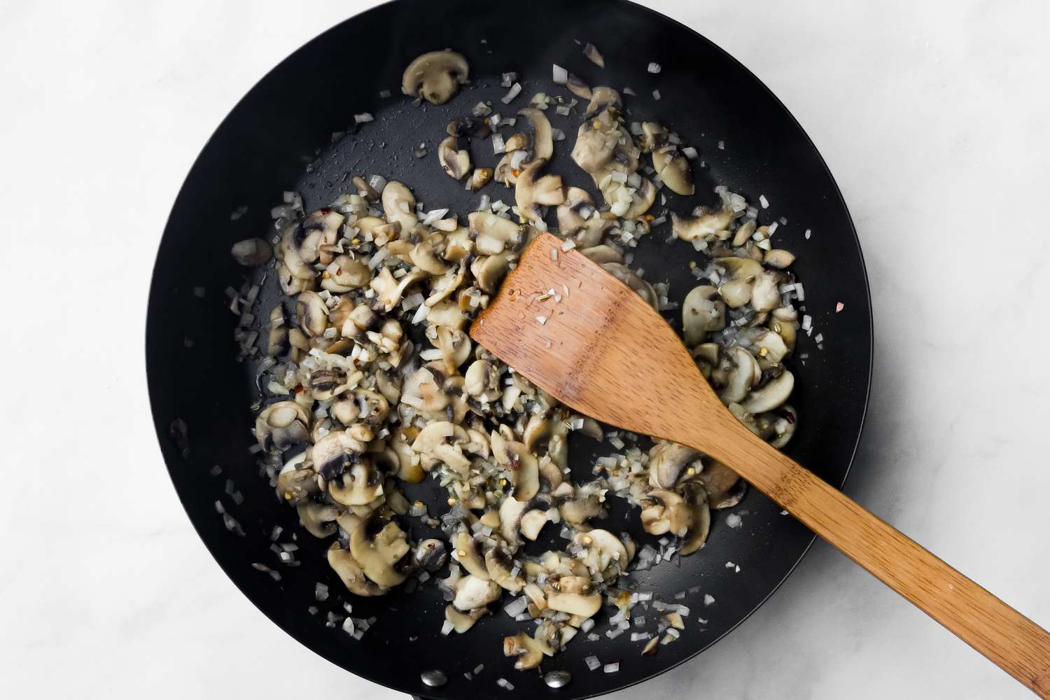 Add shallots to the black skillet.