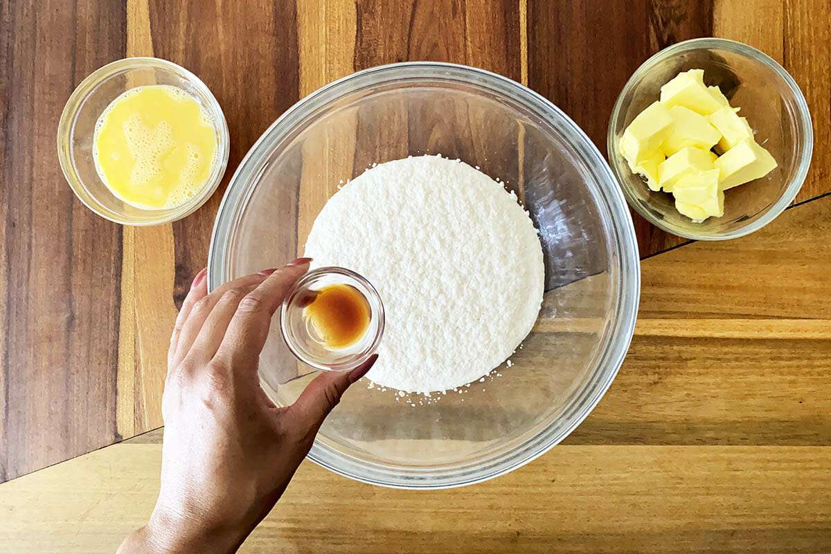 Adding vanilla to ingredients for easy gluten free cinnamon rolls.