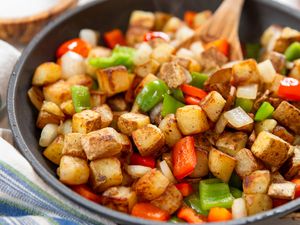 Potatoes O'Brien in a skillet at a breakfast table