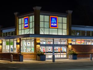 Exterior of an Aldi storefront illuminated at night