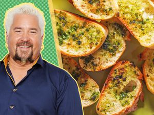 headshot cut out of Guy Fieri over a green and yellow illustrated background next to a photo of garlic bread