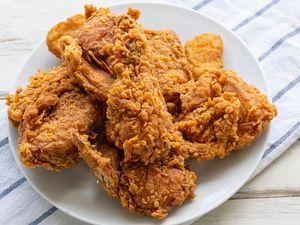 A plate of fried chicken served on a white plate