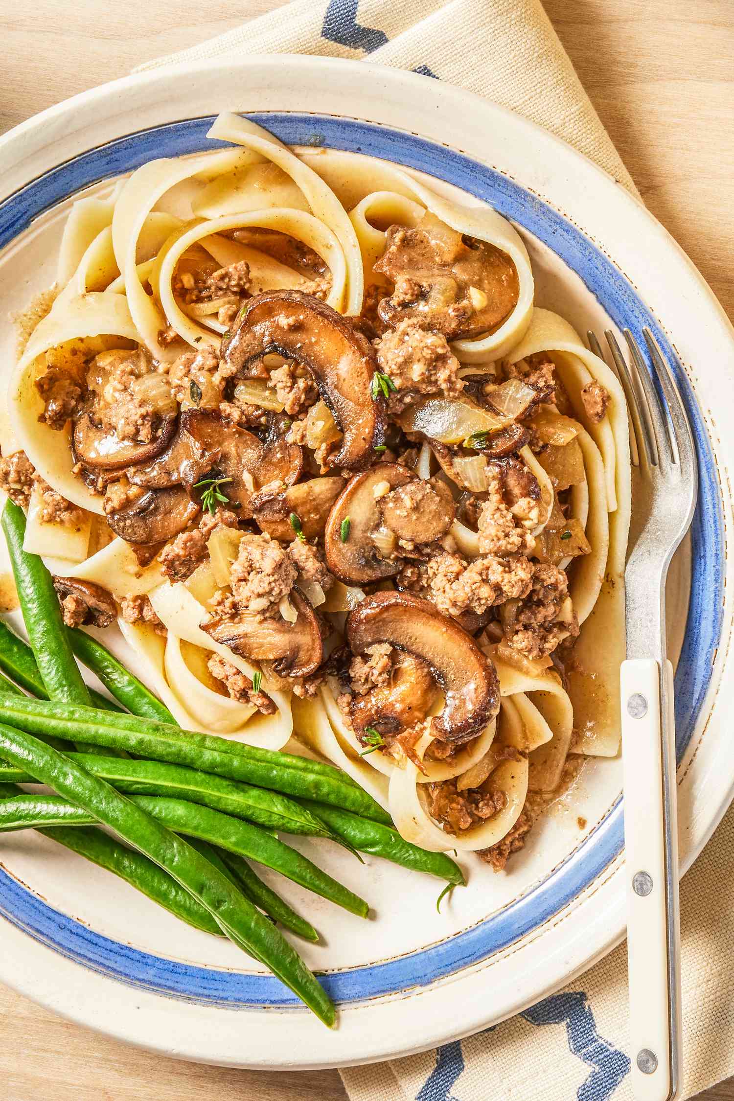 salisbury ground beef with a side of green beans on a plate