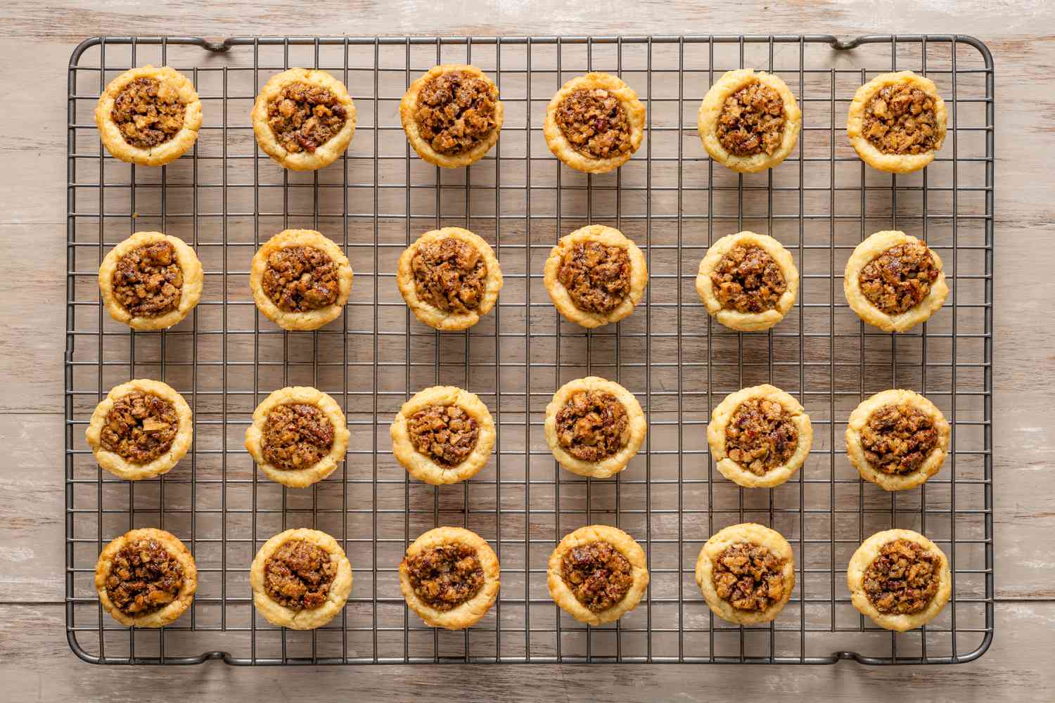 Pecan pie tassies resting on the cooling rack