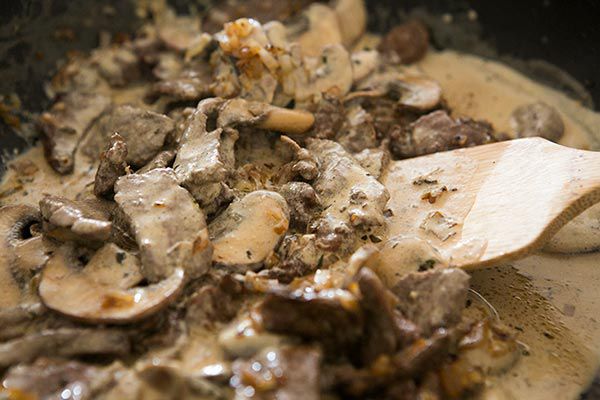 Mixing ingredients into beef stroganoff sauce