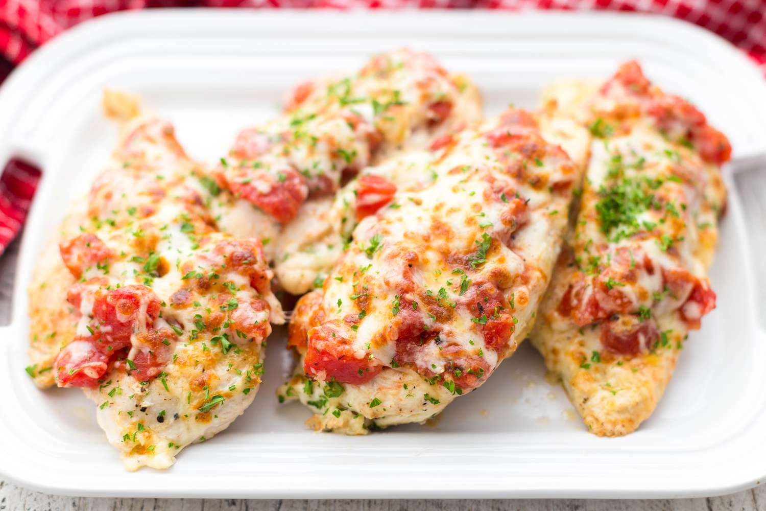 Chicken Cutlets with Cheesy Bruschetta Topping on Serving Dish
