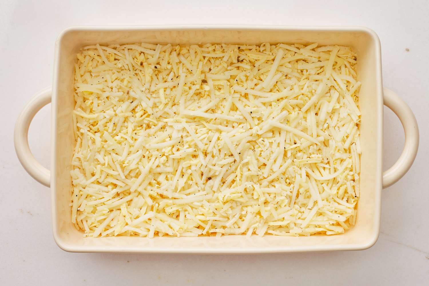 Cheese added to casserole dish for Denver omelette hashbrown casserole recipe