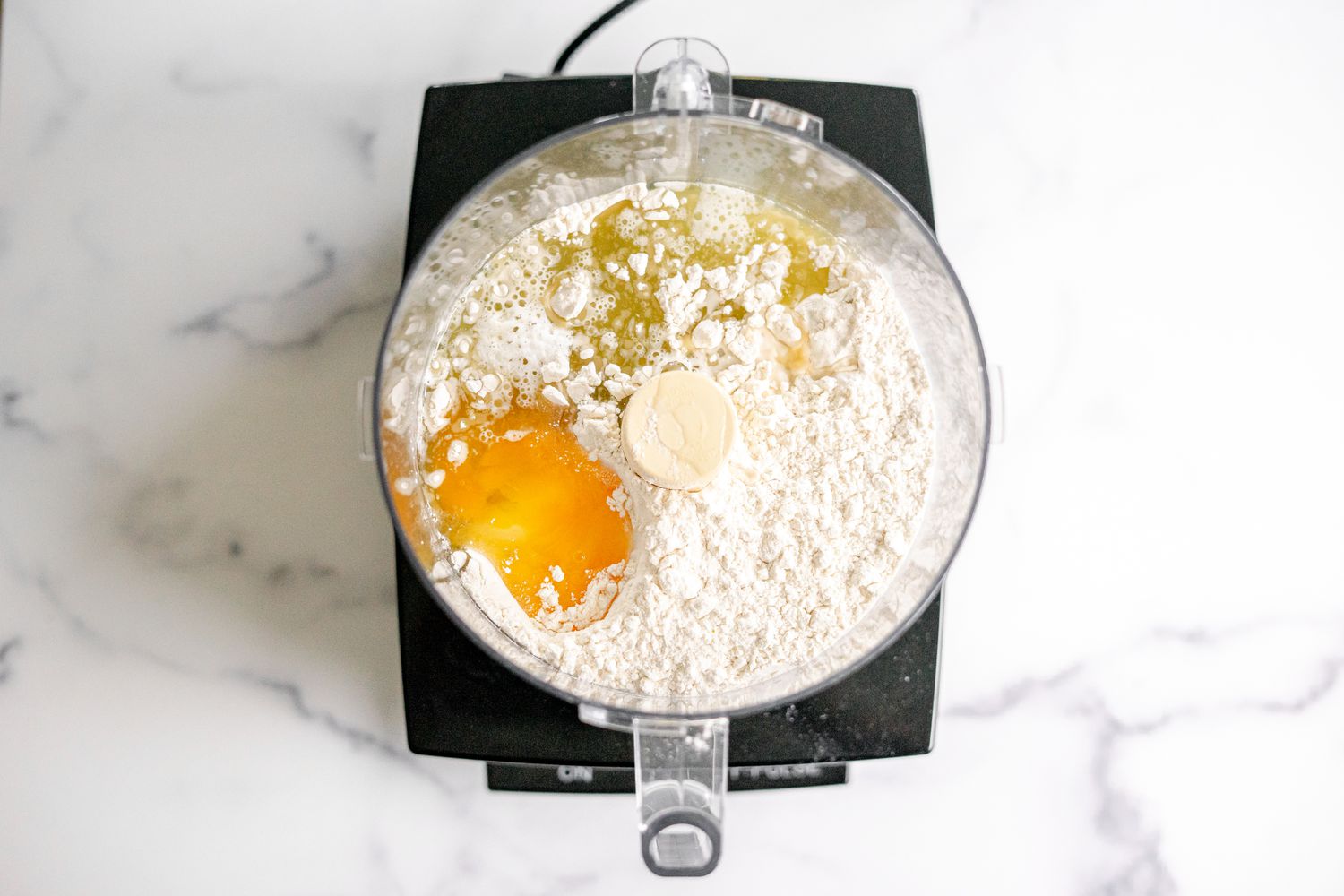 Flour, Eggs, and Oil in Food Processor for Potato Knish Recipe