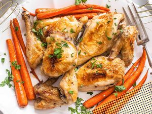 Photo of classic baked chicken and baked carrots (both topped with minced parsley) on a platter with a serving fork with yellow and deep gray dotted and lined illustrations