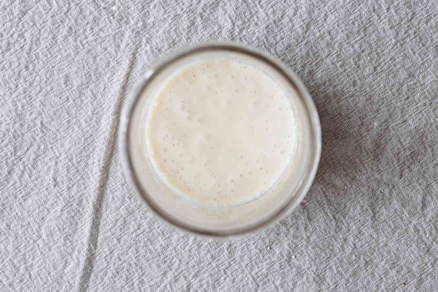 Overhead view of a mason jar with to show how to make your own sourdough starter