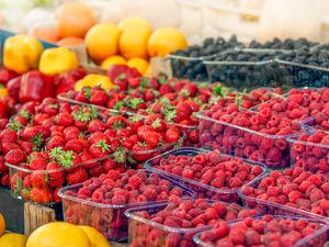 fresh summer berries (strawberries, raspberries, and blackberries) in countainers 