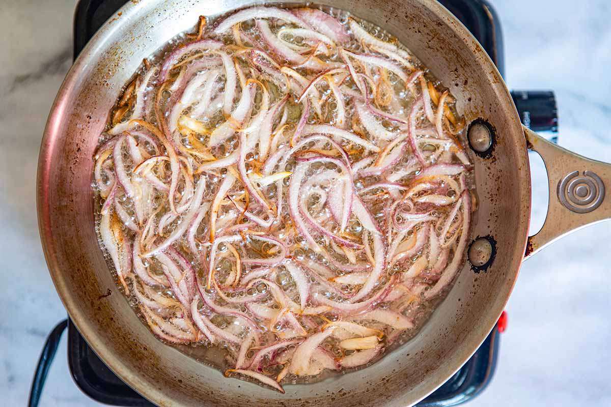 How to Make Chicken Korma - onions frying in pan