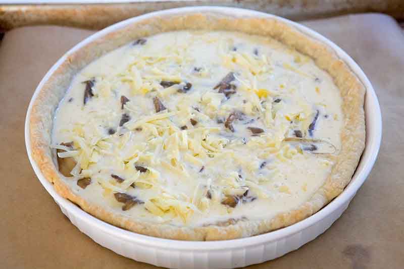 Unbaked caramelized onion and Gruyère cheese quiche