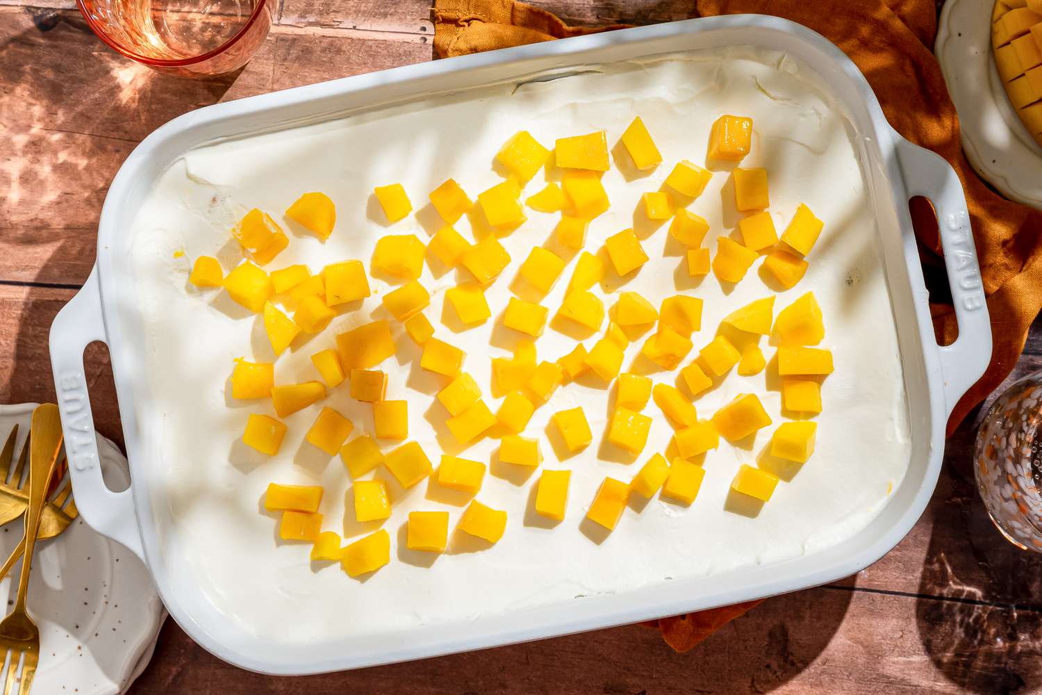 Mango float (mango royale) in a 9x13-inch pan at a table setting outside