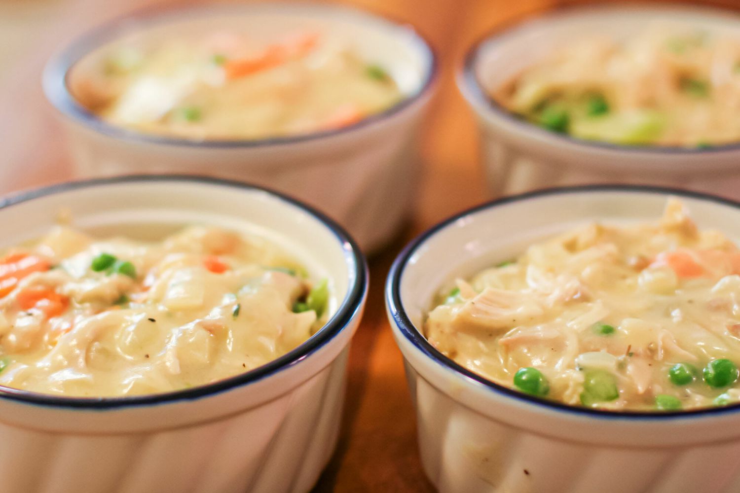 Chicken pie divided into four ramekins.