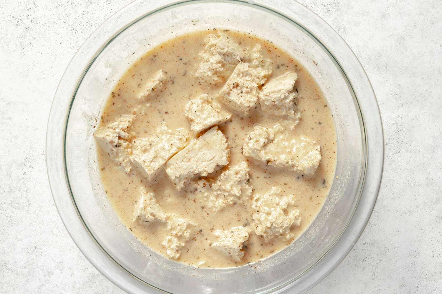 Tofu Nuggets Marinating in Bowl of "Buttermilk" Marinade for Vegan Nuggets Recipe