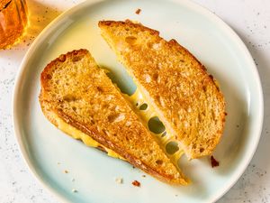 Two halves of a grilled cheese sandwich on a plate