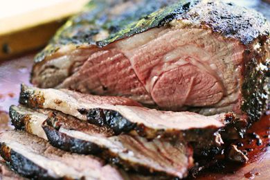 Grilled Butterflied Leg of Lamb sliced on a cutting board