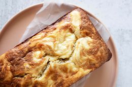 Overhead view of a loaf of cream cheese filled banana bread on a plate.