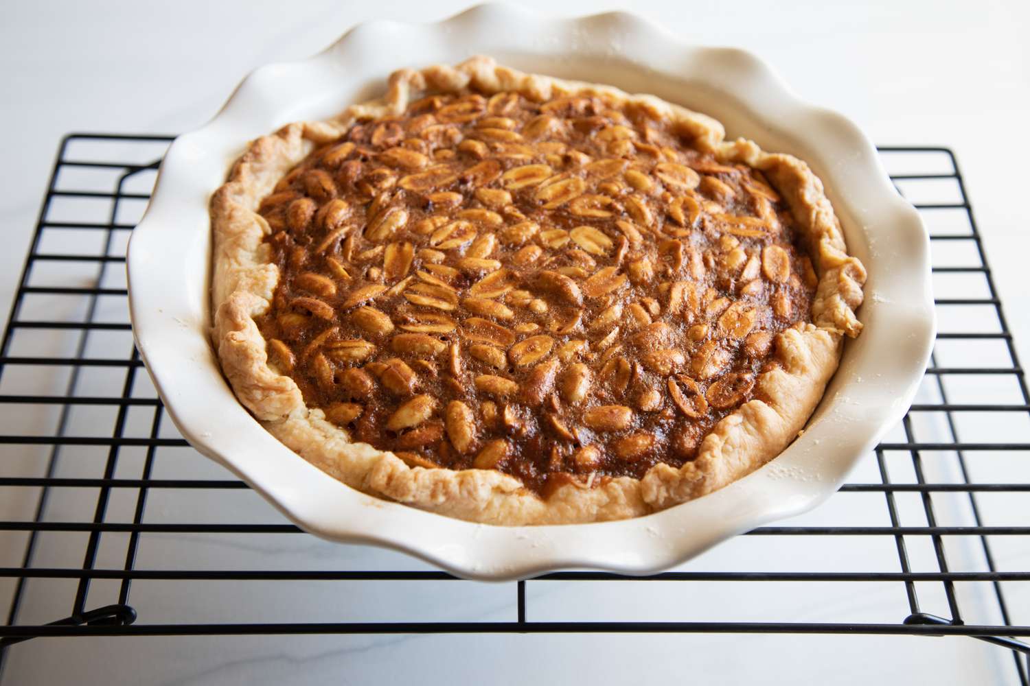 A baked Southern Peanut Pie cooling on a rack.