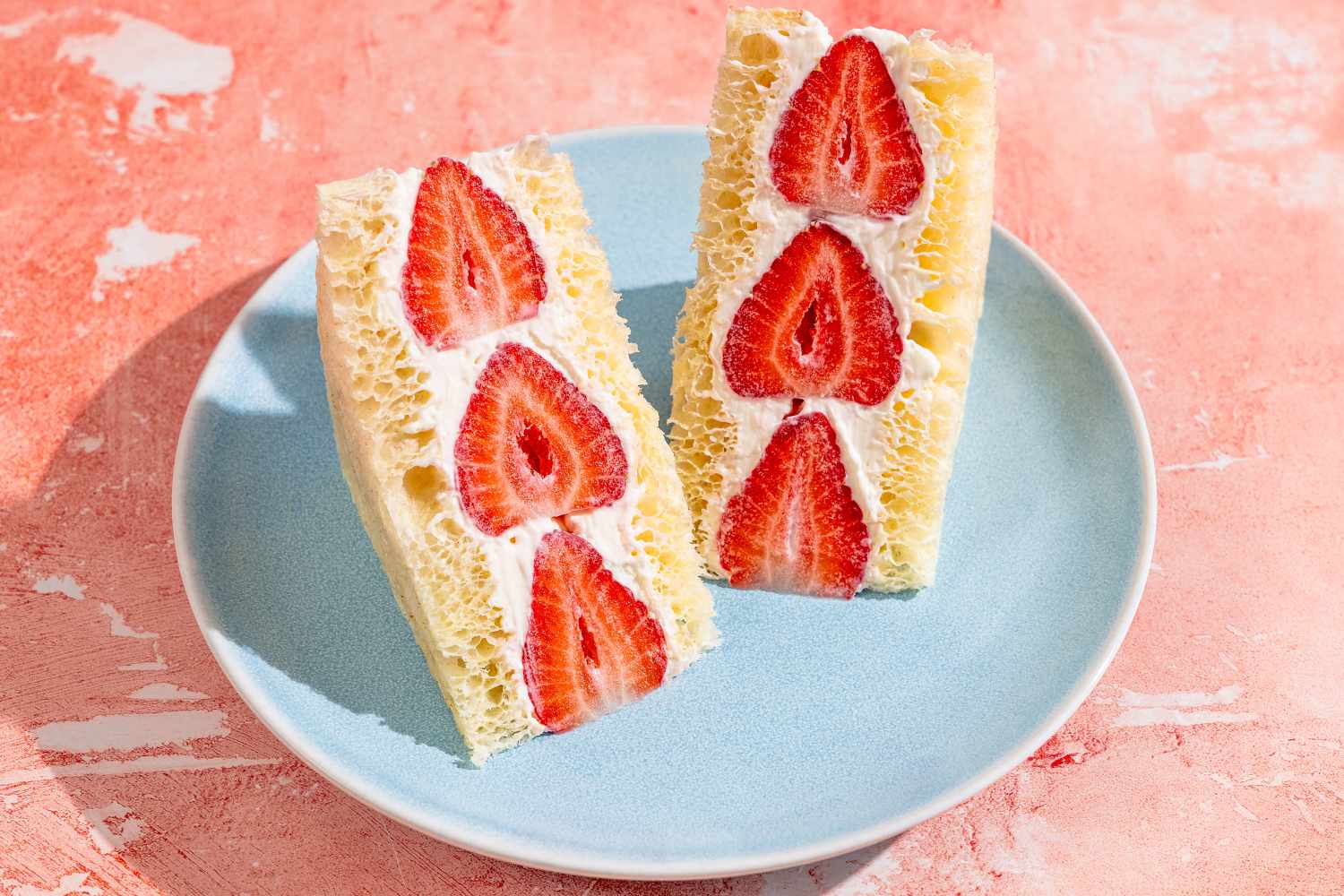 Two strawberry fruit sandos on a plate