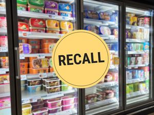 Supermarket freezer containing various ice cream products marked by a yellow circle with the word Recall over it