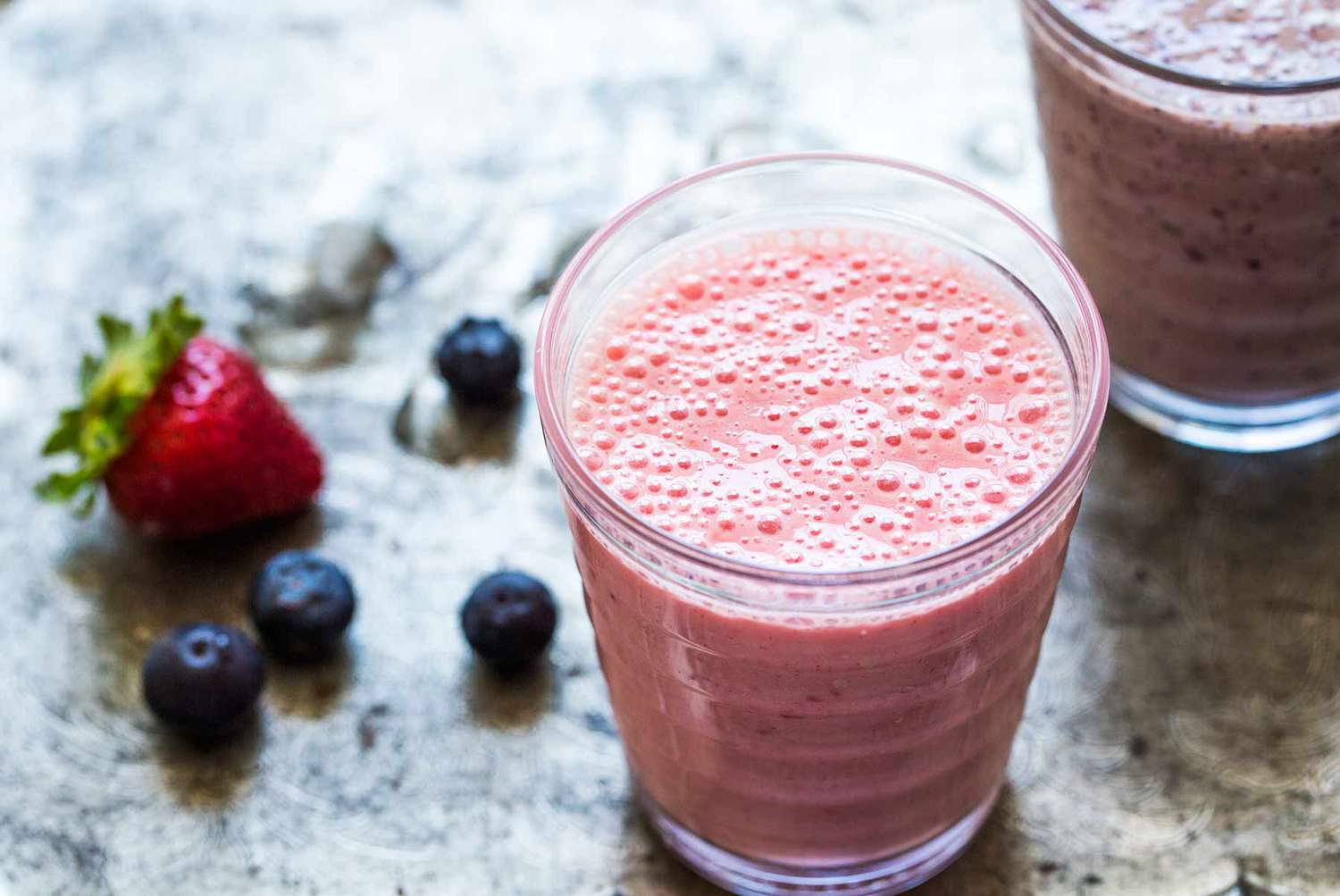 Banana Smoothie with berries on countertop