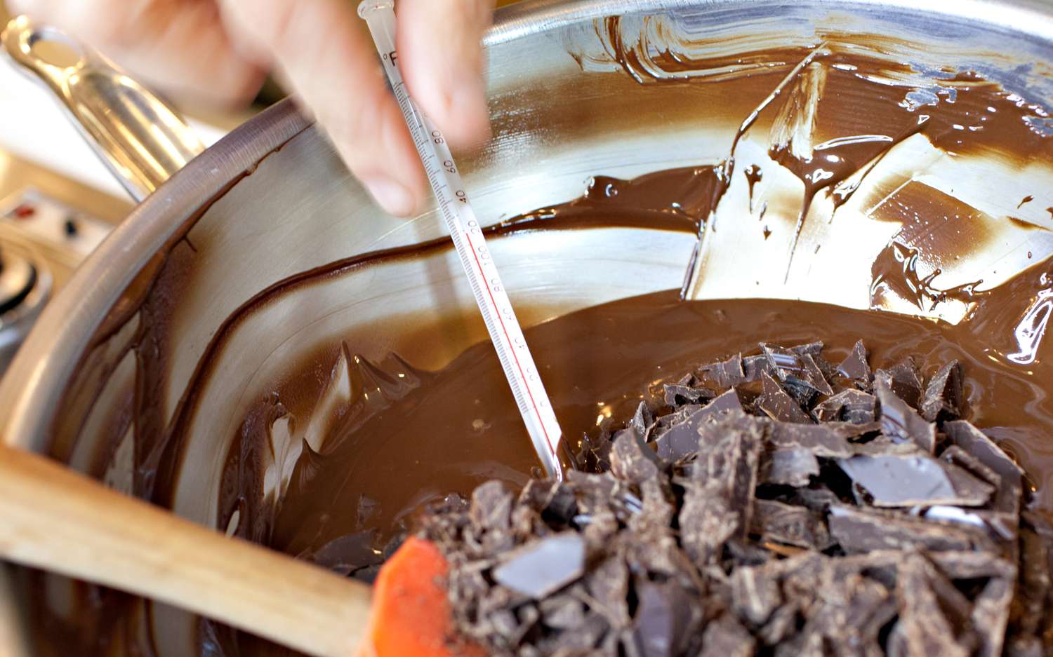 Thermometer Measuring Temperature of Melted Chocolate After More Chocolate Is Added to the Bowl for Instructions on Tempering Chocolate