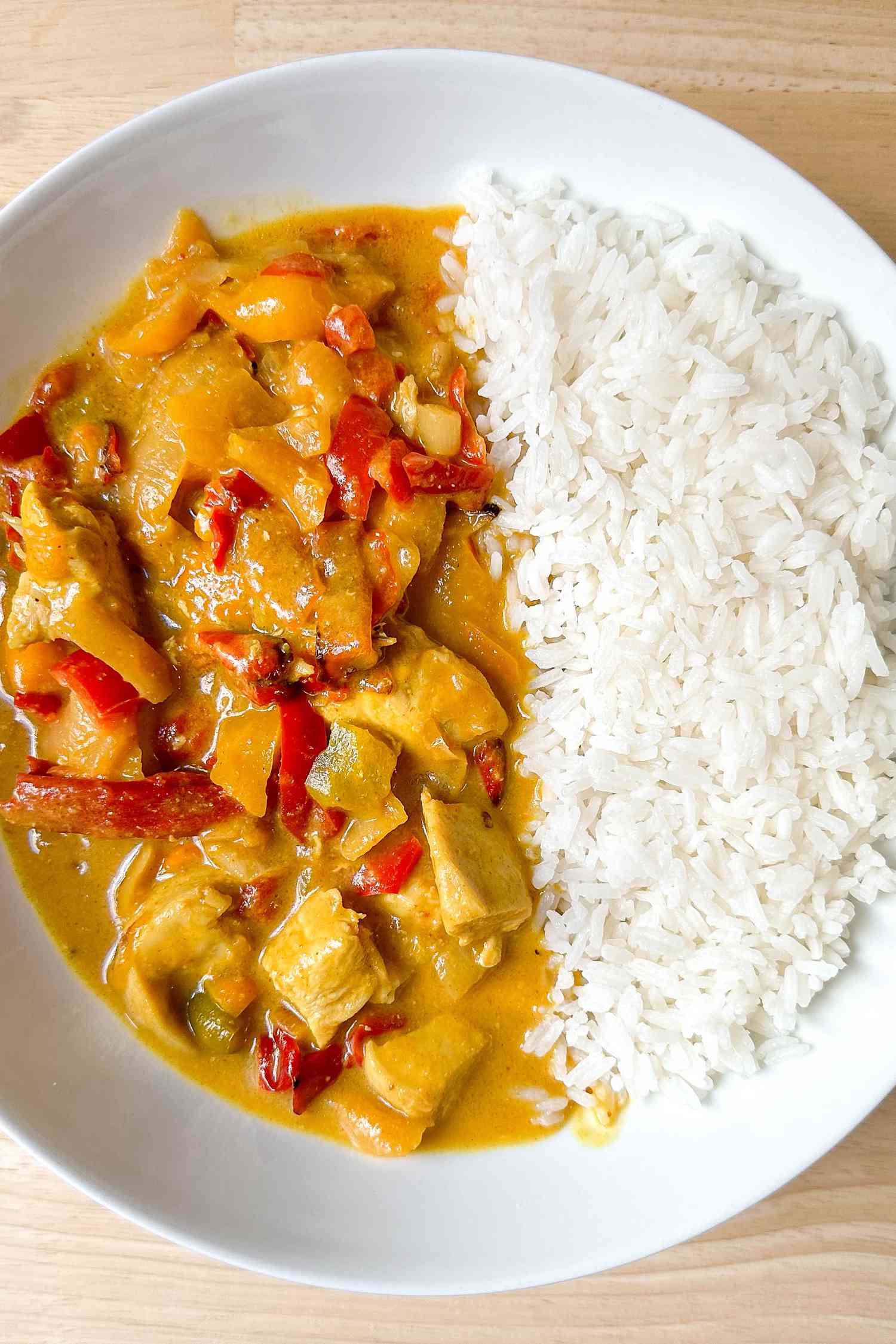 Bowl of 4-ingredient Trader Joe's chicken curry served with jasmine rice, all in a bowl 