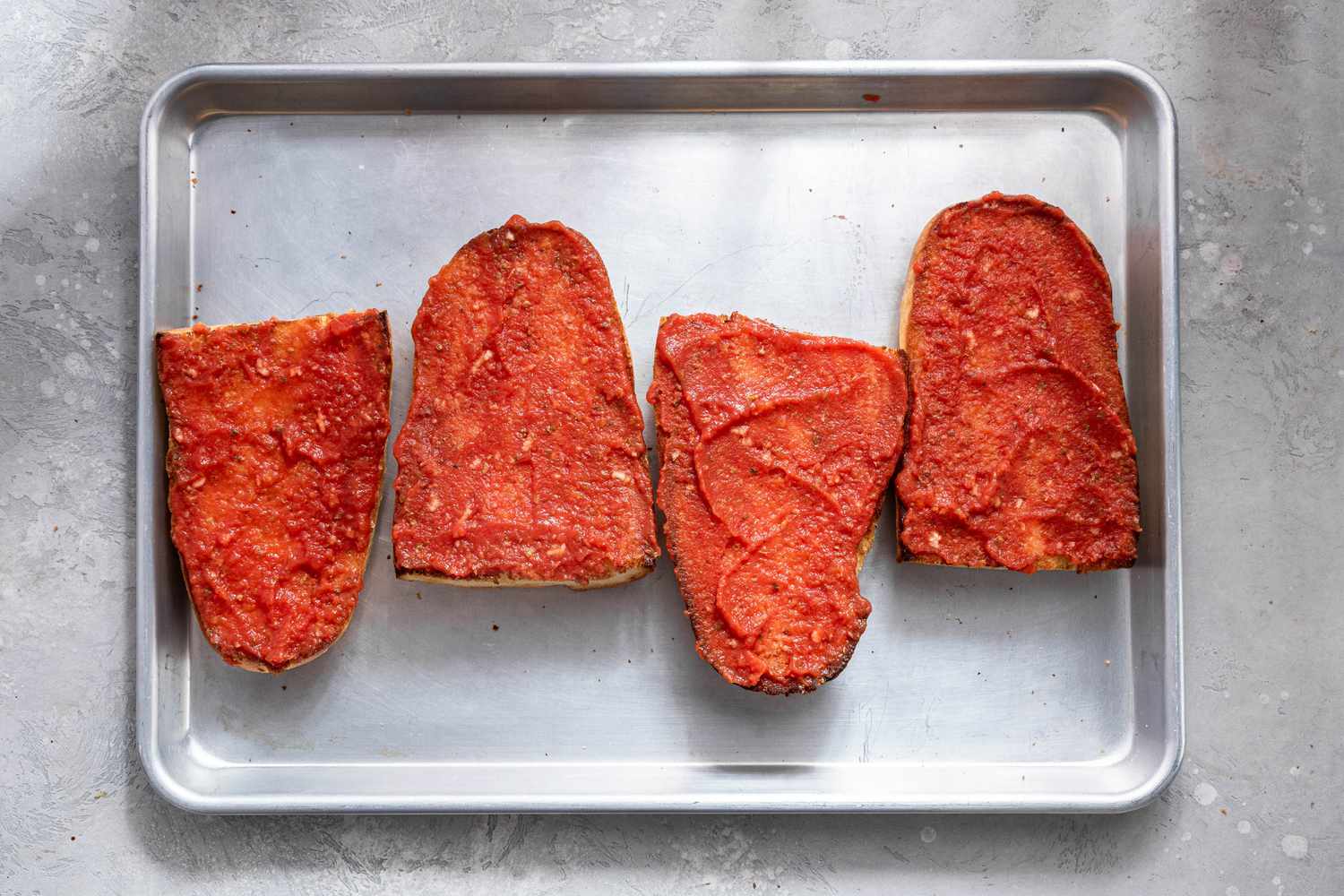 Marinara Sauce Spread Onto Each Bread Quarter 
