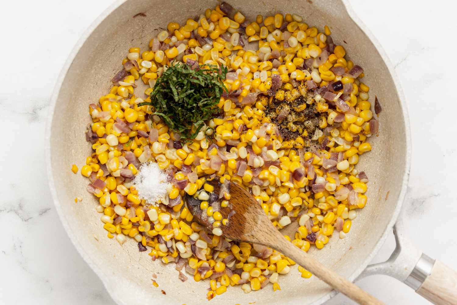 Seasoning Added to Corn in Pan for Corn and Ricotta Bruschetta Recipe