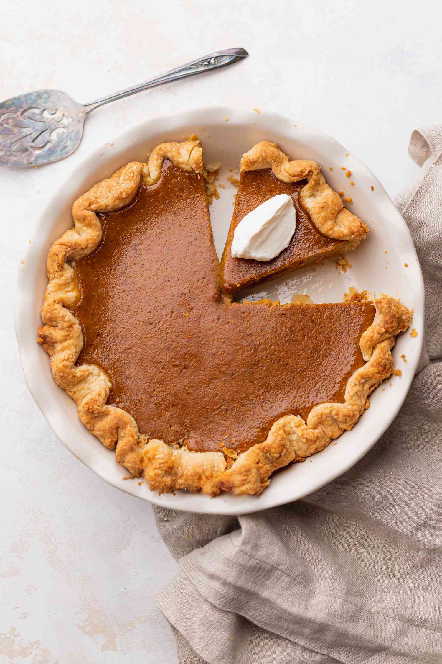 Old Fashioned Pumpkin Pie in a Pie Dish with One Piece Cut