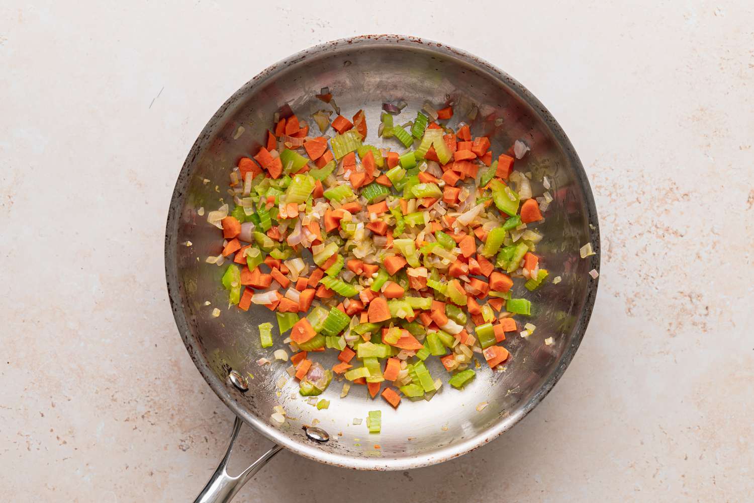 Diced vegetables in a skillet to make vegan acorn squash.