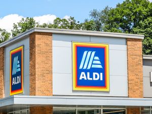 The exterior of an Aldi store with the Aldi logo visible on the building
