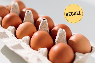 A carton of eggs with a recall label symbol