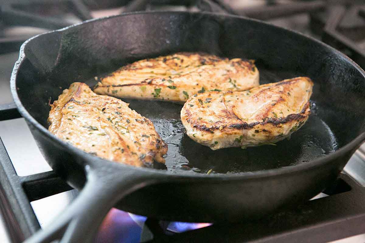 Searing chicken breasts in cast iron pan for chicken fajitas