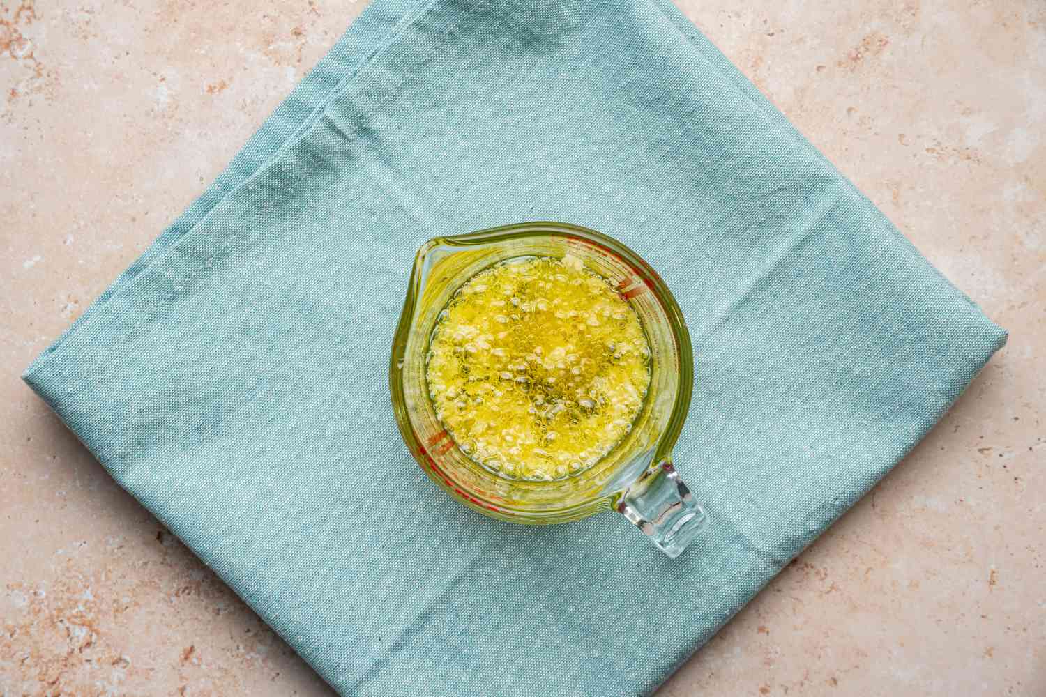 Heated Oil Mixture in a Pyrex Measuring Cup for Microwave Broccoli Recipe