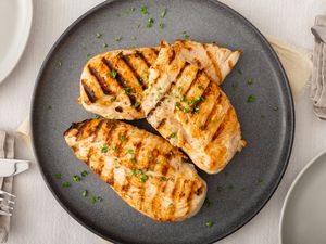 Overhead view of grilled and brined chicken on a plate.