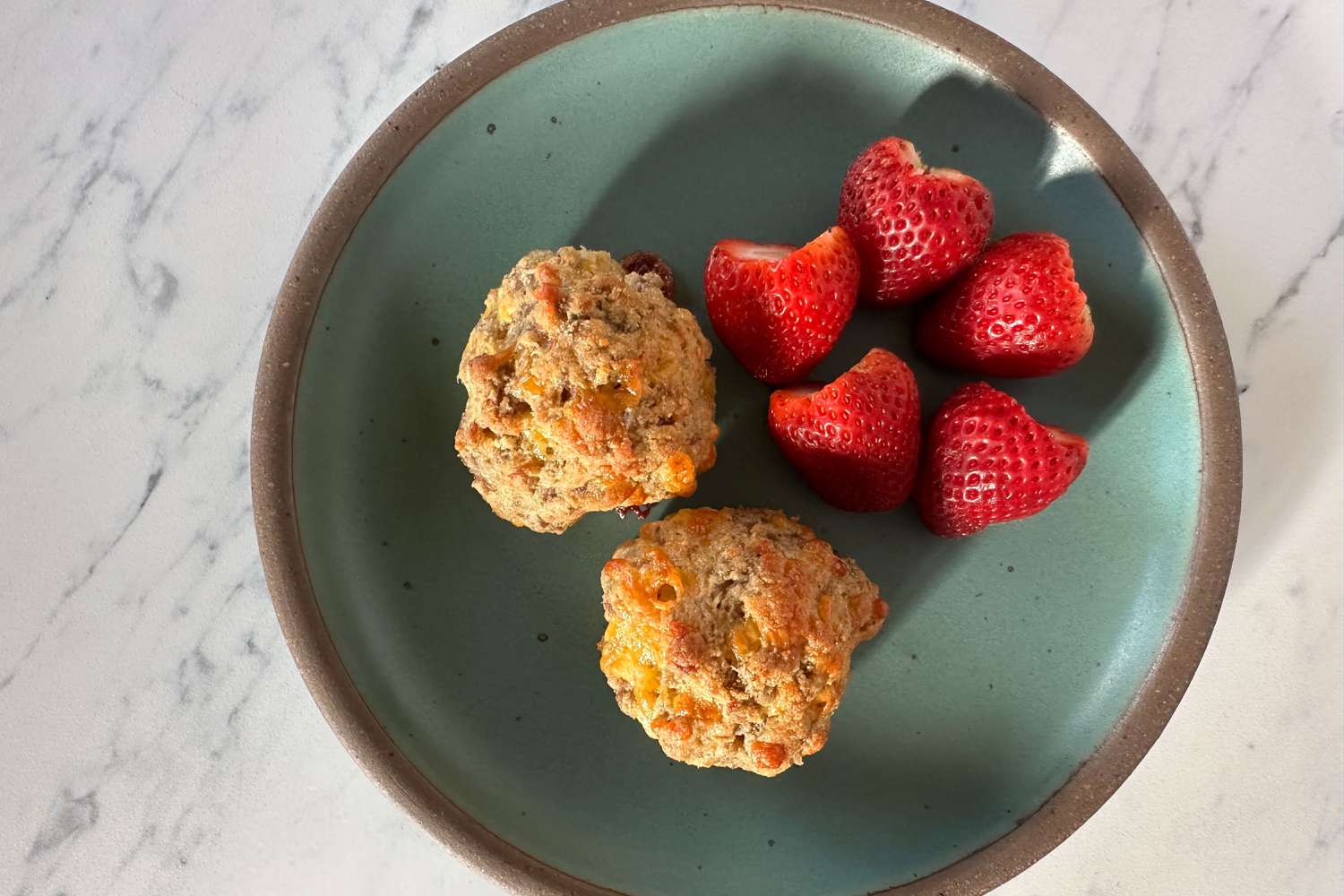 Sausage Balls on a plate with strawberries