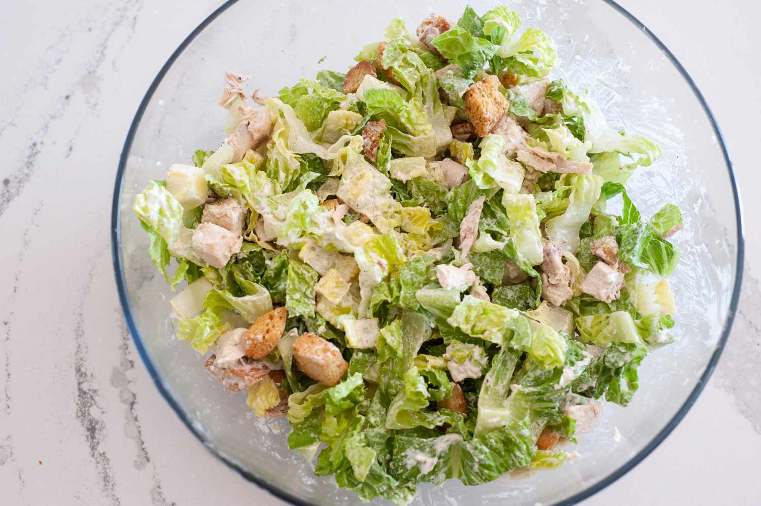 Chicken Caesar Wraps Ingredients Mixed in a Bowl
