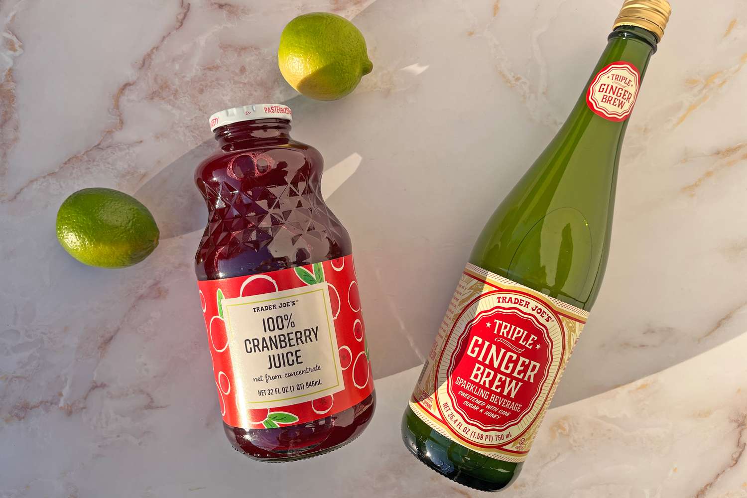 Trader Joe's products on the counter: cranberry juice, ginger brew, and limes 