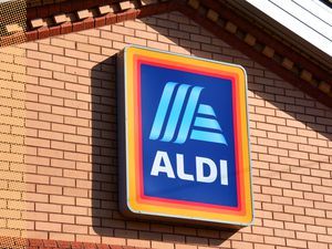 ALDI logo on a brick wall