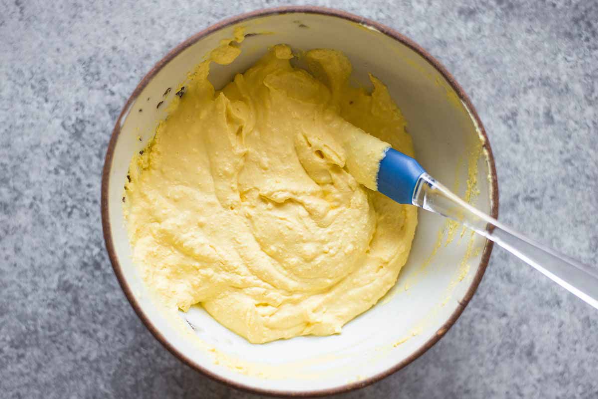 Overhead shot of deviled egg filling getting mixed together in a bowl 