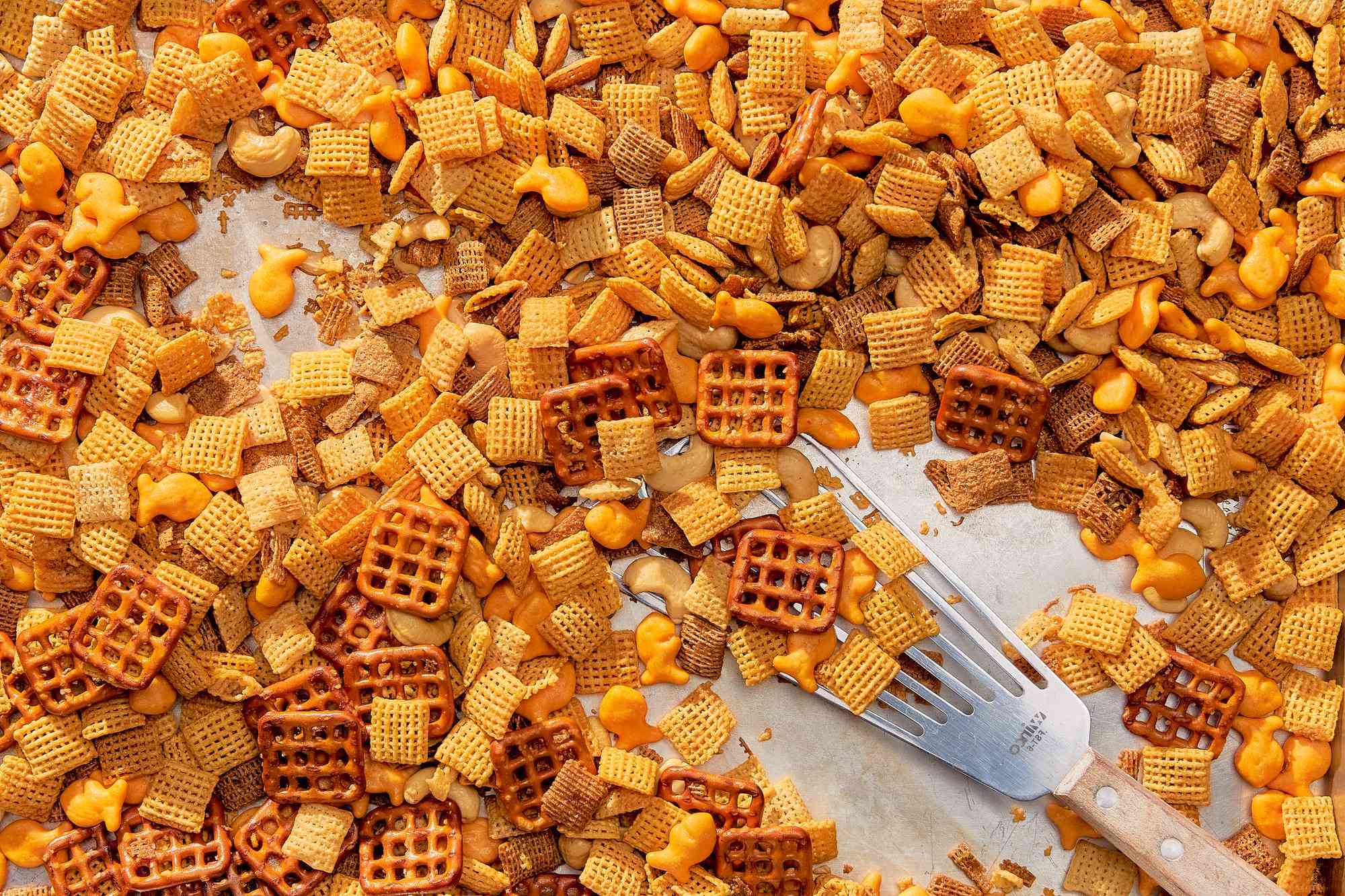 Sheetpan with chex mix recipe and a spatula